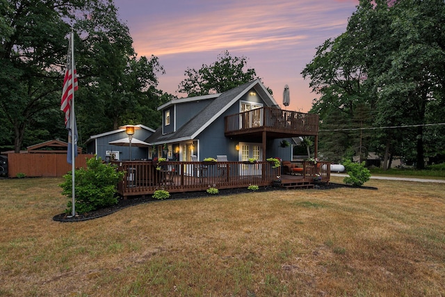 2430 140th Ave, Dorr, MI 49323 - back of house at dusk with a balcony and a deck