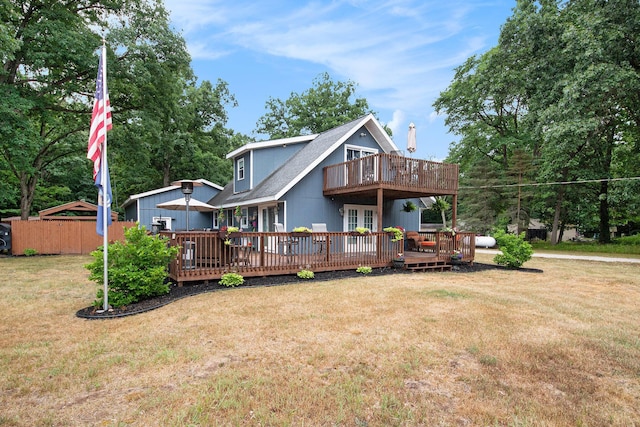 2430 140th Ave, Dorr, MI 49323 - rear view of house featuring a deck, a chimney, a balcony, french doors, and view of wooded area