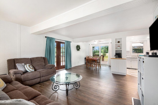 2430 140th Ave, Dorr, MI 49323 - living area featuring dark wood-style floors, plenty of natural light, a ceiling fan, and beamed ceiling