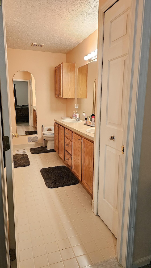 157 Carson Dr Unit 175, Westland, MI 48185 - bathroom with double vanity, a textured ceiling, and tile patterned flooring
