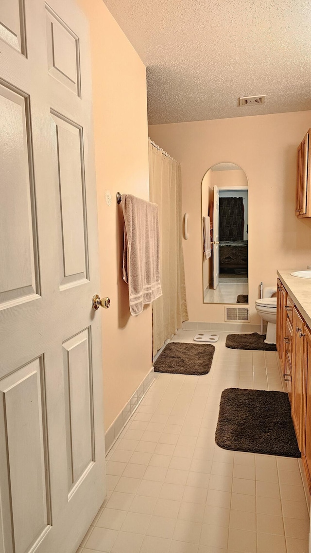 157 Carson Dr Unit 175, Westland, MI 48185 - bathroom featuring vanity, a textured ceiling, tile patterned floors, and a shower with shower curtain
