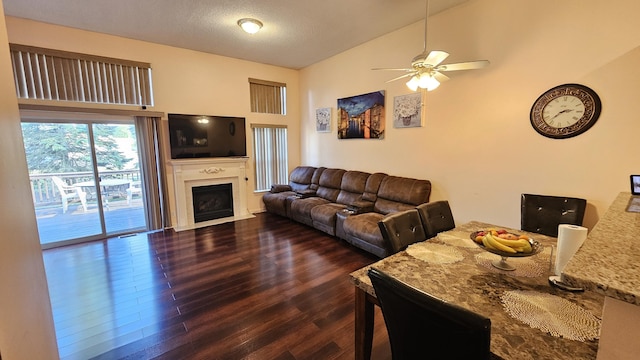 157 Carson Dr Unit 175, Westland, MI 48185 - living room featuring dark wood-type flooring, a ceiling fan, a fireplace with flush hearth, and high vaulted ceiling