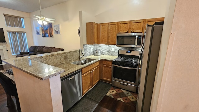 157 Carson Dr Unit 175, Westland, MI 48185 - kitchen with appliances with stainless steel finishes, a peninsula, brown cabinetry, and backsplash