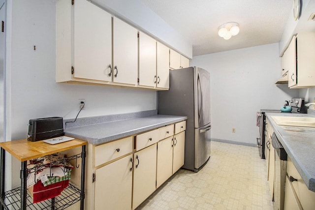 1560 G Ave W, Kalamazoo, MI 49009 - kitchen with appliances with stainless steel finishes and baseboards