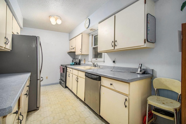 1560 G Ave W, Kalamazoo, MI 49009 - kitchen featuring stainless steel appliances, under cabinet range hood, a textured ceiling, and light floors