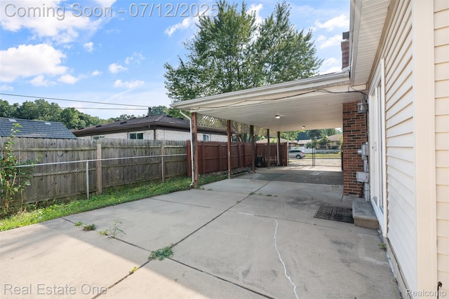 15679 Gulley St, Taylor, MI 48180 - view of patio / terrace featuring concrete driveway and a carport