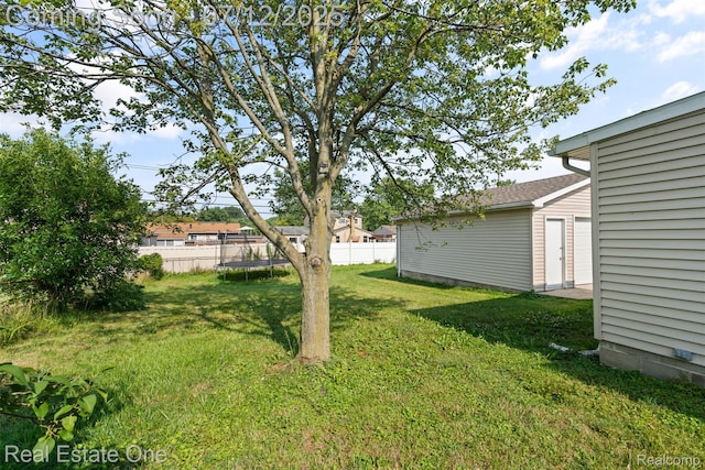15679 Gulley St, Taylor, MI 48180 - view of yard featuring a trampoline and an outbuilding