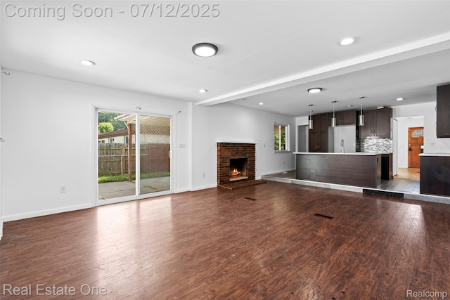 15679 Gulley St, Taylor, MI 48180 - unfurnished living room with a fireplace, wood finished floors, healthy amount of natural light, and recessed lighting