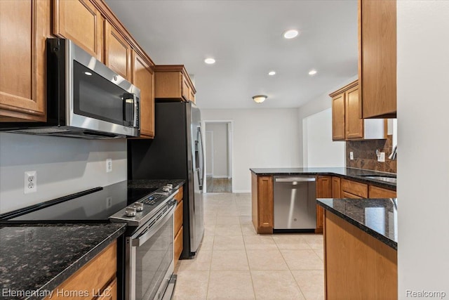 21142 Michael Ct, Saint Clair Shores, MI 48081 - kitchen with appliances with stainless steel finishes, a peninsula, brown cabinets, tasteful backsplash, and dark stone countertops