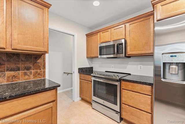 21142 Michael Ct, Saint Clair Shores, MI 48081 - kitchen with appliances with stainless steel finishes, dark stone counters, decorative backsplash, and light tile patterned floors