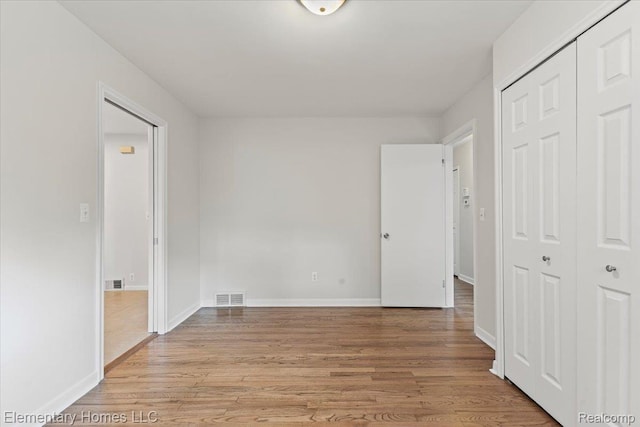 21142 Michael Ct, Saint Clair Shores, MI 48081 - unfurnished bedroom featuring light wood-style flooring and a closet