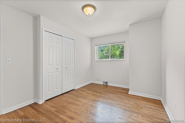 21142 Michael Ct, Saint Clair Shores, MI 48081 - unfurnished bedroom featuring light wood-type flooring and a closet