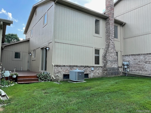 29494 Sylvan Ln Unit 6, Farmington Hills, MI 48334 - back of property with brick siding, a lawn, a deck, and a chimney