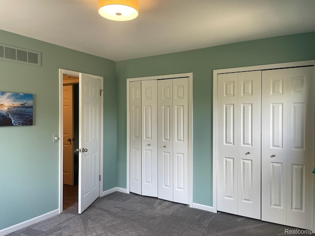 29494 Sylvan Ln Unit 6, Farmington Hills, MI 48334 - unfurnished bedroom with dark carpet and multiple closets