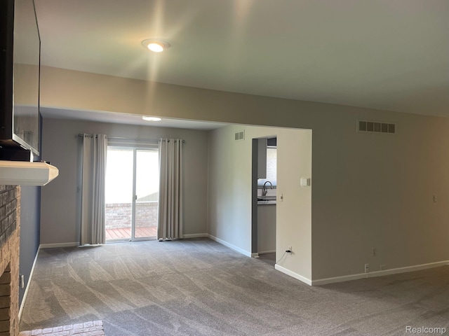 29494 Sylvan Ln Unit 6, Farmington Hills, MI 48334 - unfurnished living room with a fireplace and carpet flooring