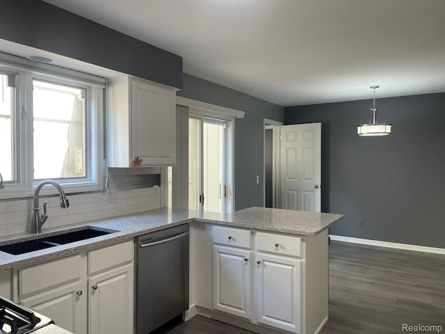 29494 Sylvan Ln Unit 6, Farmington Hills, MI 48334 - kitchen featuring a peninsula, stainless steel dishwasher, and white cabinetry