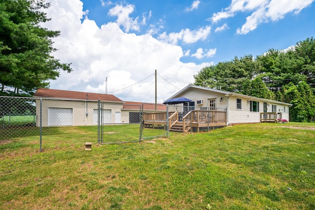 28644 Elm St, Dowagiac, MI 49047 - rear view of house with a deck, a detached garage, and a gate