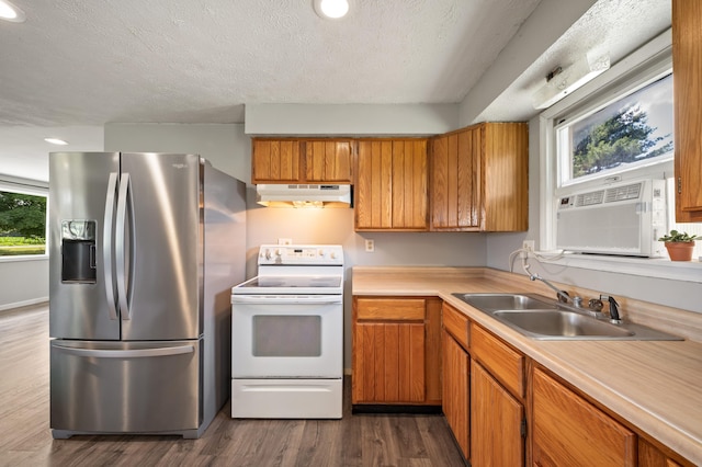 28644 Elm St, Dowagiac, MI 49047 - kitchen featuring stainless steel fridge, electric stove, under cabinet range hood, light countertops, and dark wood-style flooring