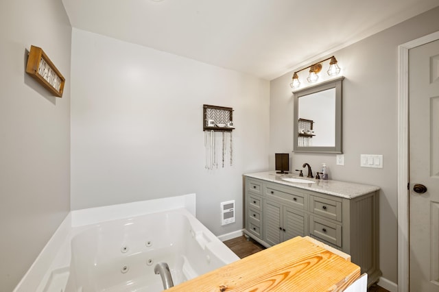 28644 Elm St, Dowagiac, MI 49047 - full bath featuring a jetted tub, vanity, heating unit, and wood finished floors