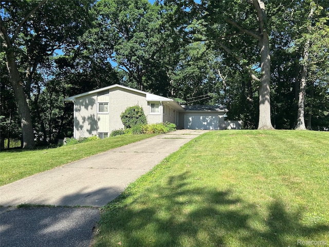 4230 Wendell Rd, West Bloomfield, MI 48323 - view of front of house featuring a front lawn, concrete driveway, and brick siding