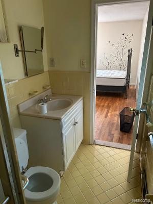4230 Wendell Rd, West Bloomfield, MI 48323 - bathroom featuring vanity, a wainscoted wall, and tile patterned floors
