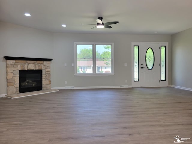 2844 1st St, Monroe, MI 48162 - unfurnished living room featuring ceiling fan, wood finished floors, a stone fireplace, and recessed lighting