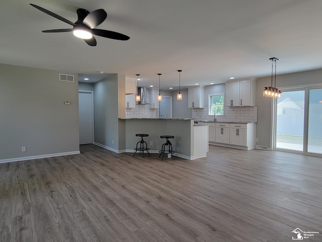 2844 1st St, Monroe, MI 48162 - unfurnished living room with light wood-style floors, a ceiling fan, and recessed lighting