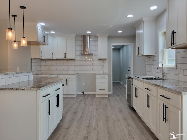 2844 1st St, Monroe, MI 48162 - kitchen featuring wall chimney exhaust hood, light stone countertops, light wood finished floors, backsplash, and pendant lighting