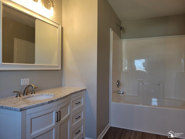 2844 1st St, Monroe, MI 48162 - bathroom with wood finished floors, vanity, and washtub / shower combination