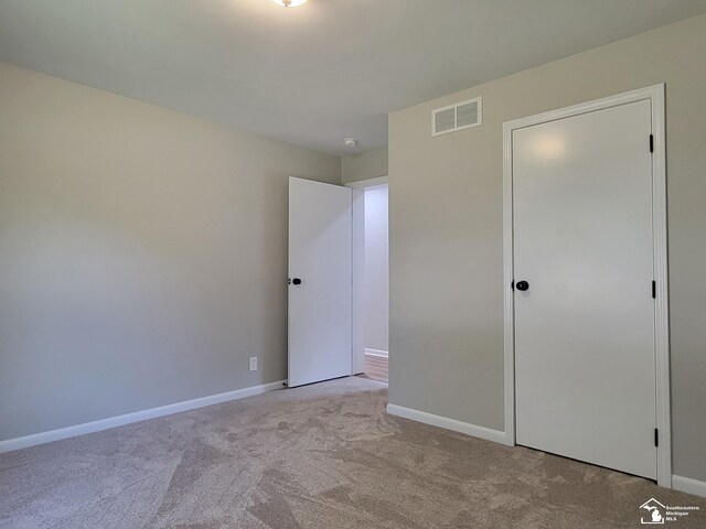 2844 1st St, Monroe, MI 48162 - unfurnished bedroom with carpet flooring and baseboards