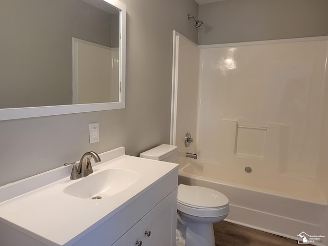 2844 1st St, Monroe, MI 48162 - bathroom featuring vanity, washtub / shower combination, and wood finished floors