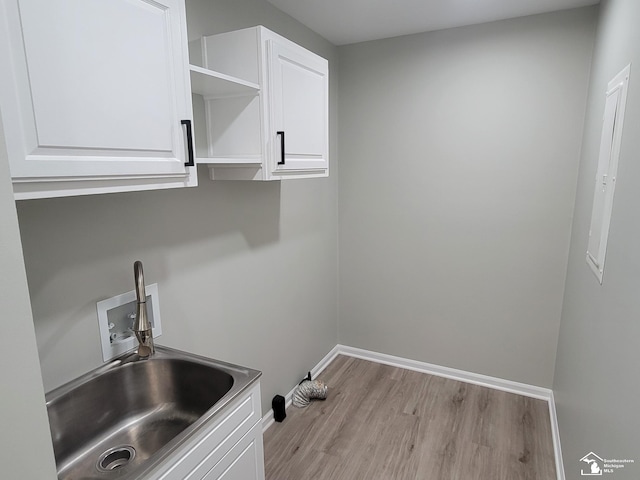 2844 1st St, Monroe, MI 48162 - laundry room with hookup for a washing machine, cabinet space, and wood finished floors