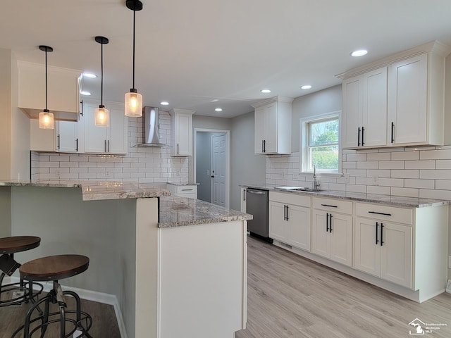 2844 1st St, Monroe, MI 48162 - kitchen with wall chimney exhaust hood, dishwasher, a breakfast bar area, decorative backsplash, and light stone counters