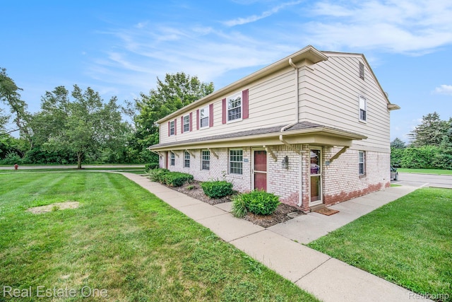 204 Princeton Dr, South Lyon, MI 48178 - view of front facade featuring brick siding and a front lawn