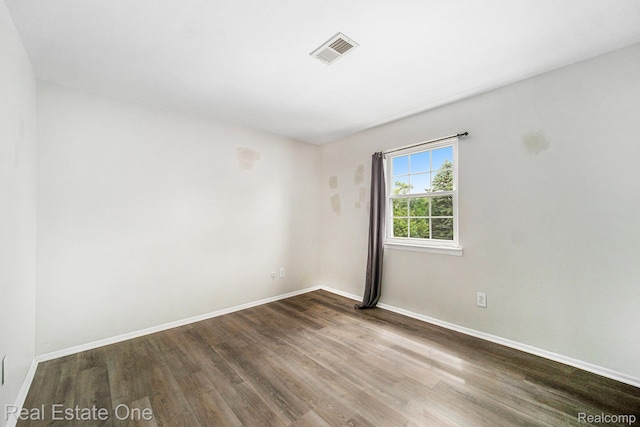 204 Princeton Dr, South Lyon, MI 48178 - spare room with wood finished floors and baseboards
