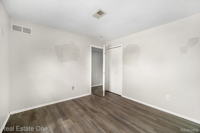 204 Princeton Dr, South Lyon, MI 48178 - unfurnished bedroom with dark wood finished floors and a closet