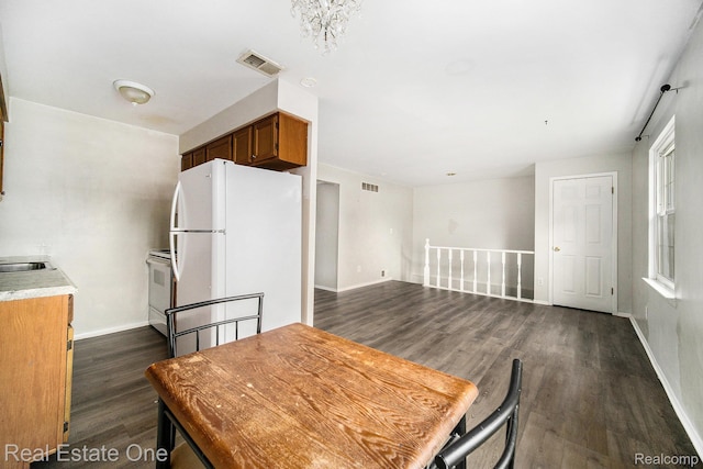 204 Princeton Dr, South Lyon, MI 48178 - dining area featuring dark wood-type flooring and baseboards