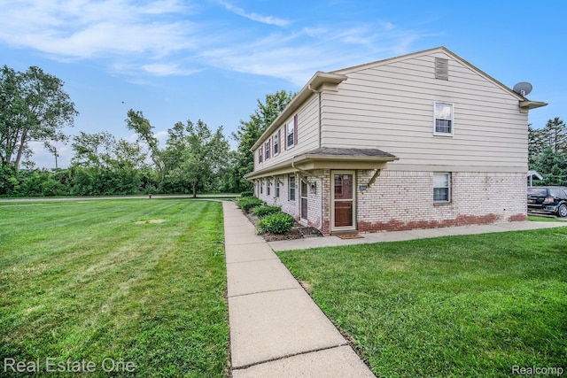 204 Princeton Dr, South Lyon, MI 48178 - view of property exterior with brick siding and a yard