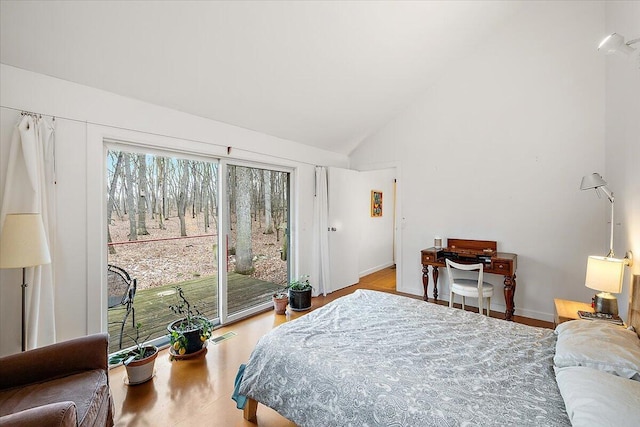 7227 Wheeler Rd, Whitmore Lake, MI 48189 - bedroom with access to exterior, wood finished floors, and high vaulted ceiling