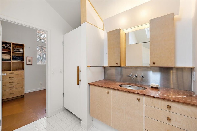 7227 Wheeler Rd, Whitmore Lake, MI 48189 - bathroom with vanity, tile patterned floors, lofted ceiling, and backsplash