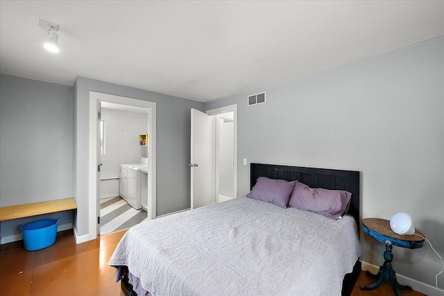 7227 Wheeler Rd, Whitmore Lake, MI 48189 - bedroom featuring washing machine and clothes dryer and connected bathroom
