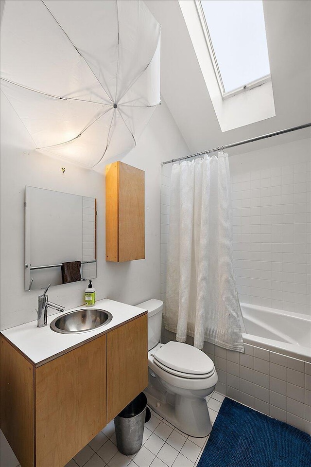 7227 Wheeler Rd, Whitmore Lake, MI 48189 - full bath with a skylight, tile patterned flooring, vanity, tiled shower / bath, and lofted ceiling