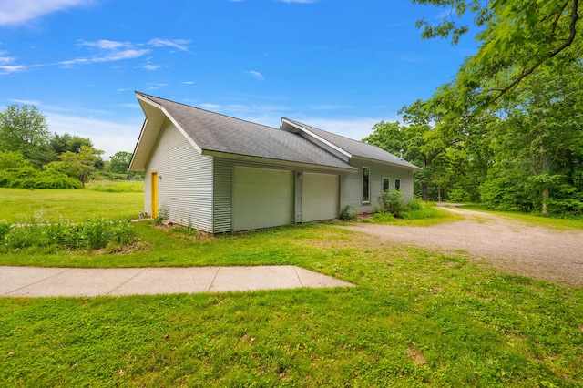 7227 Wheeler Rd, Whitmore Lake, MI 48189 - view of property exterior with driveway, a yard, an attached garage, and a shingled roof