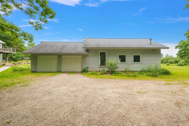 7227 Wheeler Rd, Whitmore Lake, MI 48189 - view of front of property featuring driveway, roof with shingles, and an attached garage