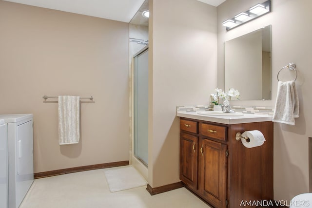 8608 Woodruff Dr SW, Byron Center, MI 49315 - bathroom featuring washing machine and clothes dryer, a stall shower, and vanity