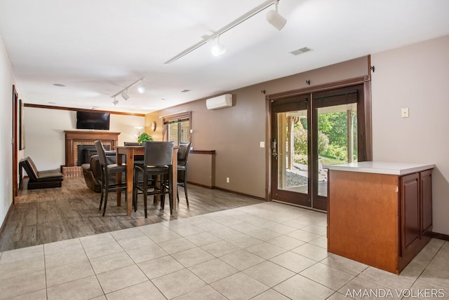 8608 Woodruff Dr SW, Byron Center, MI 49315 - dining space with rail lighting, an AC wall unit, and healthy amount of natural light