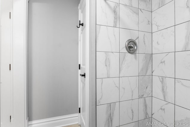 8608 Woodruff Dr SW, Byron Center, MI 49315 - bathroom featuring tiled shower and baseboards