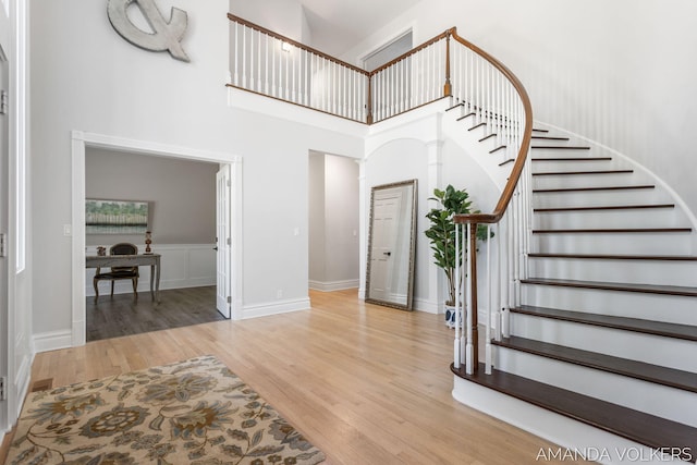 8608 Woodruff Dr SW, Byron Center, MI 49315 - entrance foyer with a high ceiling, wood finished floors, and stairway