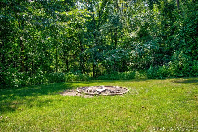 8608 Woodruff Dr SW, Byron Center, MI 49315 - view of grassy yard with an outdoor fire pit