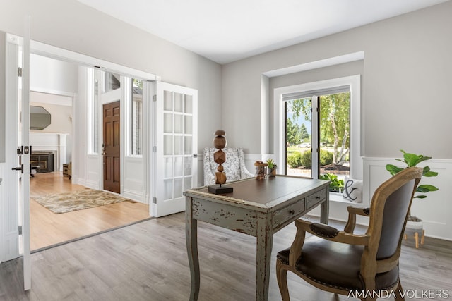 8608 Woodruff Dr SW, Byron Center, MI 49315 - office space with a decorative wall, wood finished floors, a wainscoted wall, and french doors